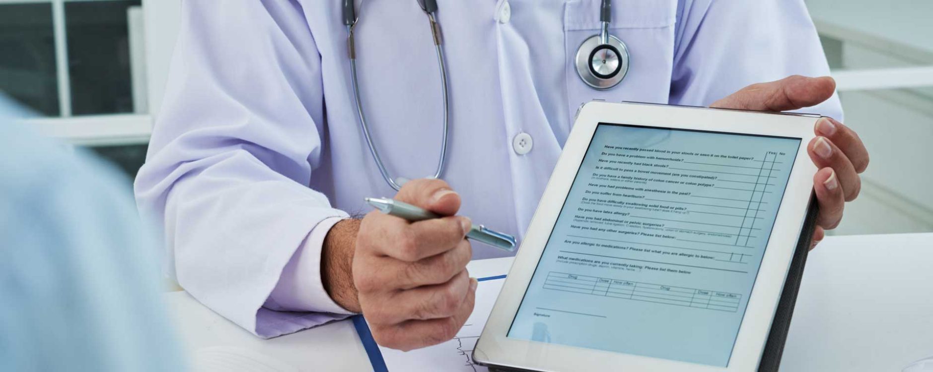 Doctor showing a digital medical form on a tablet, symbolizing medical billing services in Orlando, FL.